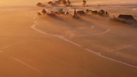 Aerial view of Wergea fields and farm near foggy river at golden hour Stock Footage 313154654