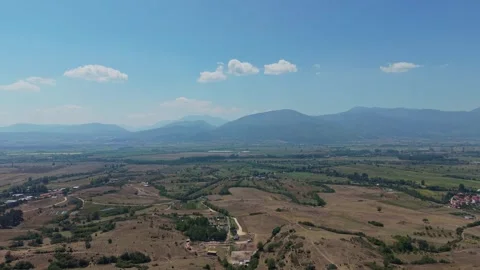 Aerial view of Western Rhodopes fields with distant Pirin Mountains Stock Footage 343622056