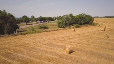 Aerial View Wheat Field After Harvest with Hay Bales and Highway Stock Footage 101300289