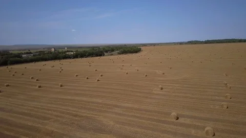 Aerial View Wheat Field After Harvest with Hay Bales and Highway Stock Footage 101300427