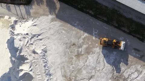 Aerial view of a wheel loader moving salt at Narta Lagoon, Albania. Stock Footage 337092650