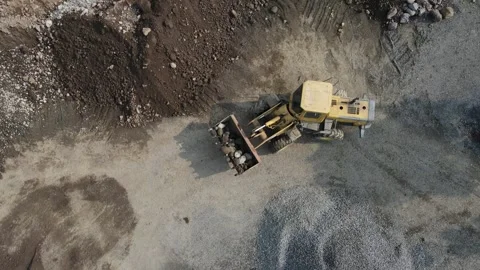 Aerial view of a wheel loader moving rocks in Pegalongan, Indonesia. Stock Footage 337203458