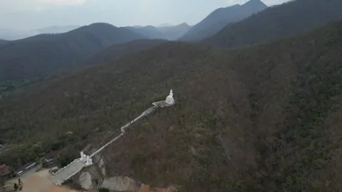 Aerial View of a White Buddha Statue on a Mountain Top in Pai, Mae Hong Son, Stock Footage 335570895