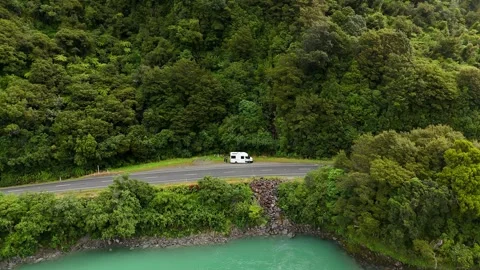 Aerial view of white campervan parked on curved highway Stock Footage 341606154