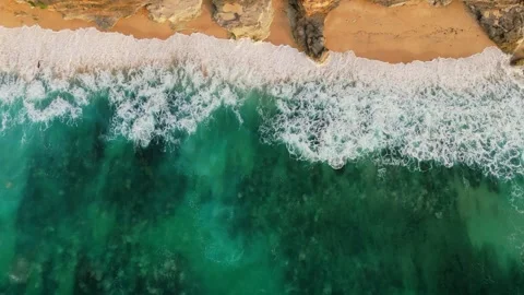 Aerial view of white-capped waves crashing on sandy beach Video stock 288465719