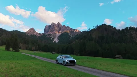 Aerial view of white car driving on scenic mountain road in the Dolomites Italy Stock Footage 320458317
