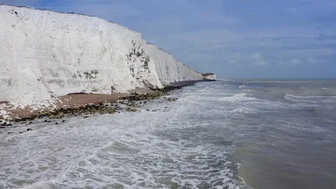 Aerial view of white cliffs, waves crashing on the seashore and a seagull Stock-Footage 124911785