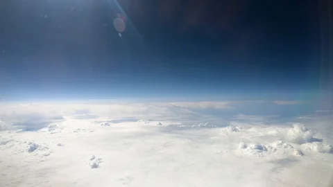 Aerial view of white clouds and blue sky from airplane window in cabin Stock-Footage 120882637