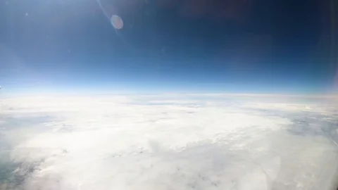 Aerial view of white clouds and blue sky in sunlight from plane window 库存影片 121354832