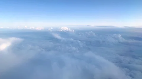 Aerial view of white clouds and sky from plane window in daylight Stock-Footage 121354874