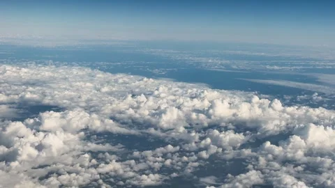 Aerial View of White Clouds and Blue Sky from Airplane Window Over USA Stock Footage 345854553