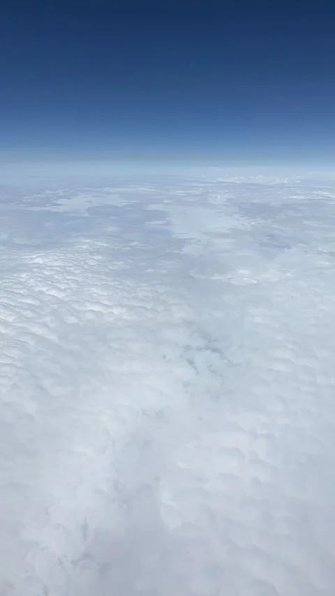 Aerial view White clouds in blue sky. View from the window of an airplane Stock Footage 312748257
