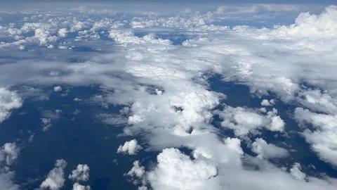 Aerial view White clouds in blue sky. View from the window of an airplane Stock Footage 314901111