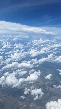 Aerial view of white clouds over green landscape Stock Photos
