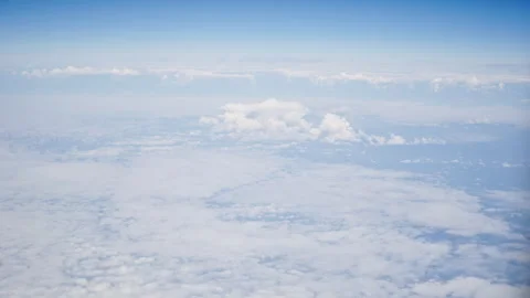 Aerial view of white, fluffy clouds from an airplane window Stock Footage 314106539