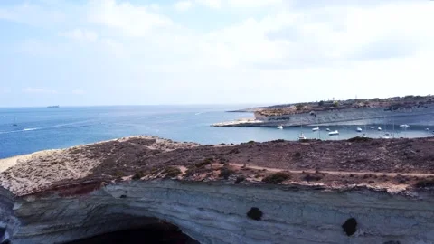 Aerial view of white limestone cliffs and yachts anchored in a blue bay on .. Stock Footage 325801389