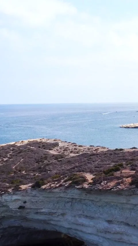 Aerial view of white limestone cliffs and yachts anchored in a blue bay on .. Stock Footage 327035614