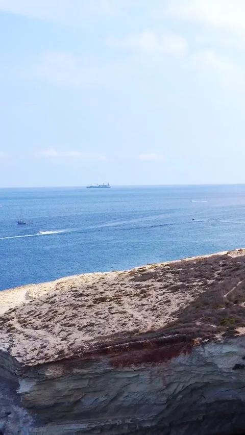 Aerial view of white limestone cliffs and yachts anchored in a blue bay on .. Stock Footage 327035699