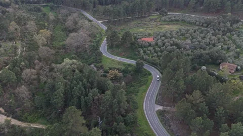 Aerial View of White Pickup Driving Through Rural Countryside on Serpentine Road Stock Footage 335295516