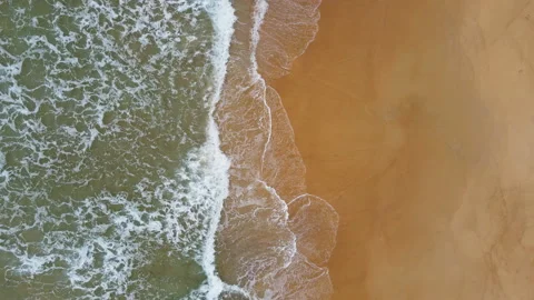 Aerial view of white sand beach and water surface texture. Foamy waves  스톡 동영상 190353097