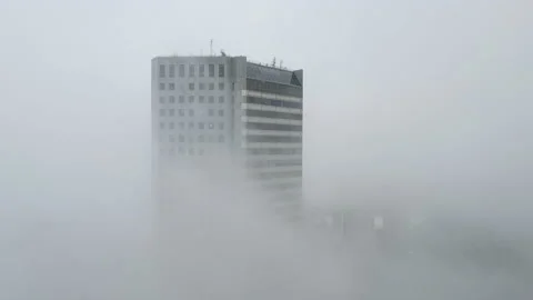 Aerial view of a white skyscraper in the clouds on a cloudy day 库存影片 227661673