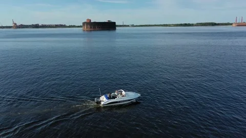 Aerial view of a white speedboat sailing against the background of Fort Stock Footage 171608862