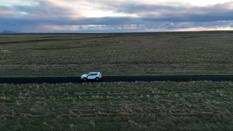 Aerial view of a white SUV driving on a rural road, Iceland. Stock Footage 337334522