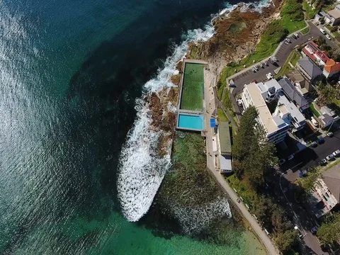 Aerial view white waves break rocks at ocean pool with horizon Stock Footage 70768964