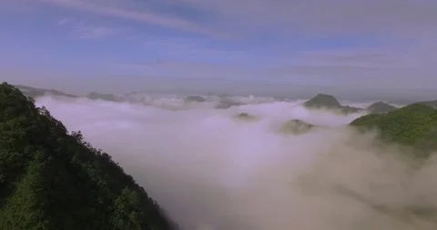 Aerial view of wide flat flow sea of clouds mountain forest peak top in mountain Stock Footage 337925654