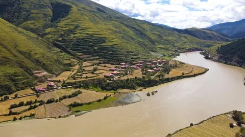 Aerial view of wide muddy river green mountain valley terrace in Aba Sichuan Video stock 337926322
