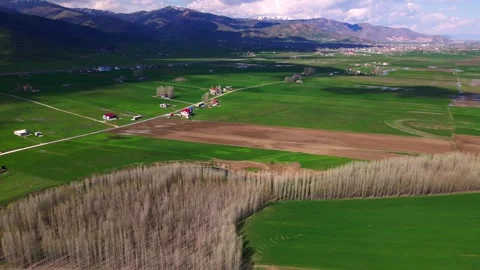 Aerial view of a wide, open plain with roads and streams running through it Stock Footage 327961305