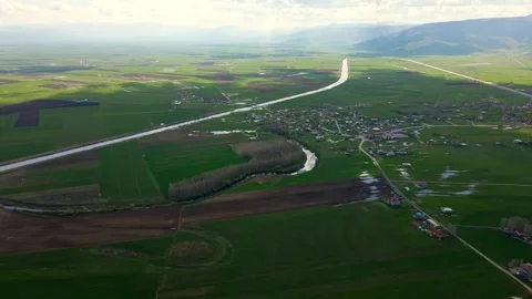 Aerial view of a wide, open plain with roads and streams running through it Stock Footage 327962636