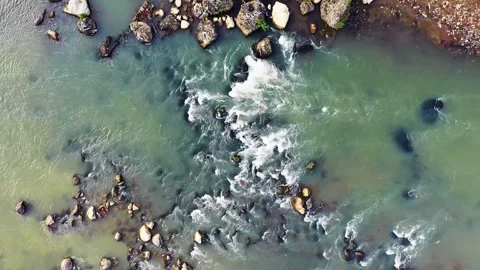 Aerial View of Wide River Flowing Between Large Rocks Stock Footage 314696939