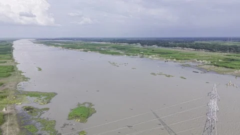 Aerial view of wide river flowing through green rural agricultural landscape Stock Footage 344514332