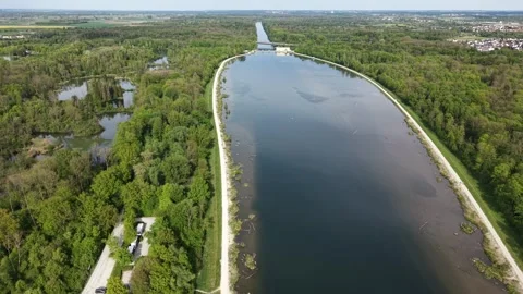 Aerial view of wide river narrowing after dam structure Видео 334027331