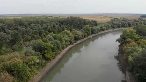 Aerial view of the wide river with two green shores 4K. Stock Footage 236962360