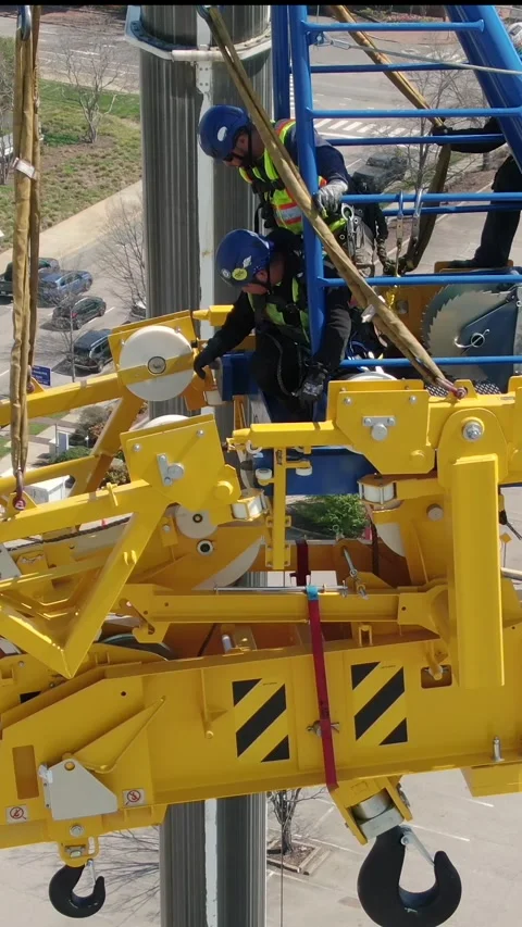 Aerial View Widescreen Close Up of Workers Assembling Tower Crane Stock Footage 331277172