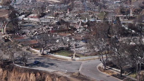 Aerial view of wildfire damage in Pacific Palisades neighborhood of Los Angeles Stock Footage 301583870