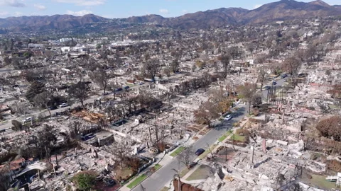 Aerial view of wildfire damage in Pacific Palisades neighborhood of Los Angeles Stock Footage 301585376