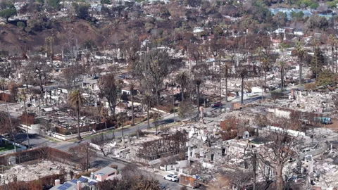 Aerial view of wildfire damage in Pacific Palisades neighborhood of Los Angeles Stock Footage 301588145
