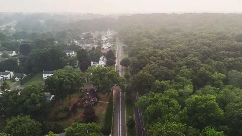 Aerial view of wildfire smoke drifting over a suburban forest... Stock Footage 340291088