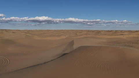 Aerial view of wind blowing sand across desert dunes, Mangystau, Kazakhstan Stock Footage 322757250