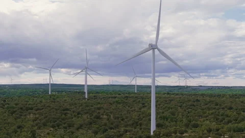 Aerial view of a wind farm generating renewable energy with spinning turbines Stock Footage 336214060