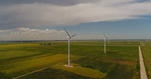 Aerial view of a wind farm on large grasslands with a storm moving in Stock Footage 113630369