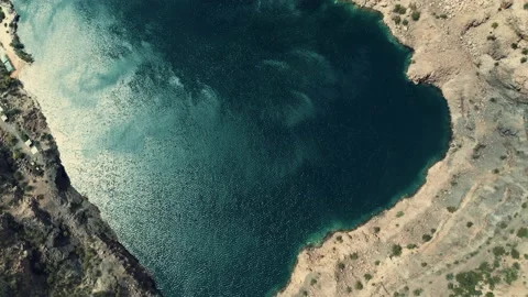 Aerial view of wind gusts on the surface of a water-filled quarry. Stock Footage 149004820