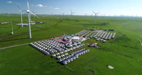 Aerial view of wind power station &amp; Mongolia tent site in China Stock Footage 95989942