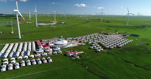 Aerial view of wind power station &amp; Mongolia tent site in China Stock Footage 95990089