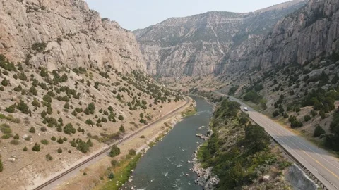 Aerial view of Wind River Canyon in Wyoming with highway and railway at sunset Stock Footage 335009869