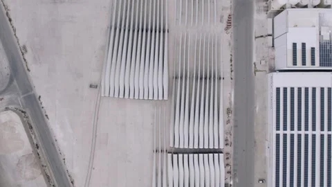 Aerial View of Wind Turbine Blades Stored in Industrial Yard Video stock 344530997