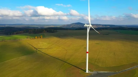 Aerial view to wind turbine. Camera flight around power plant. Stock-Footage 120119100